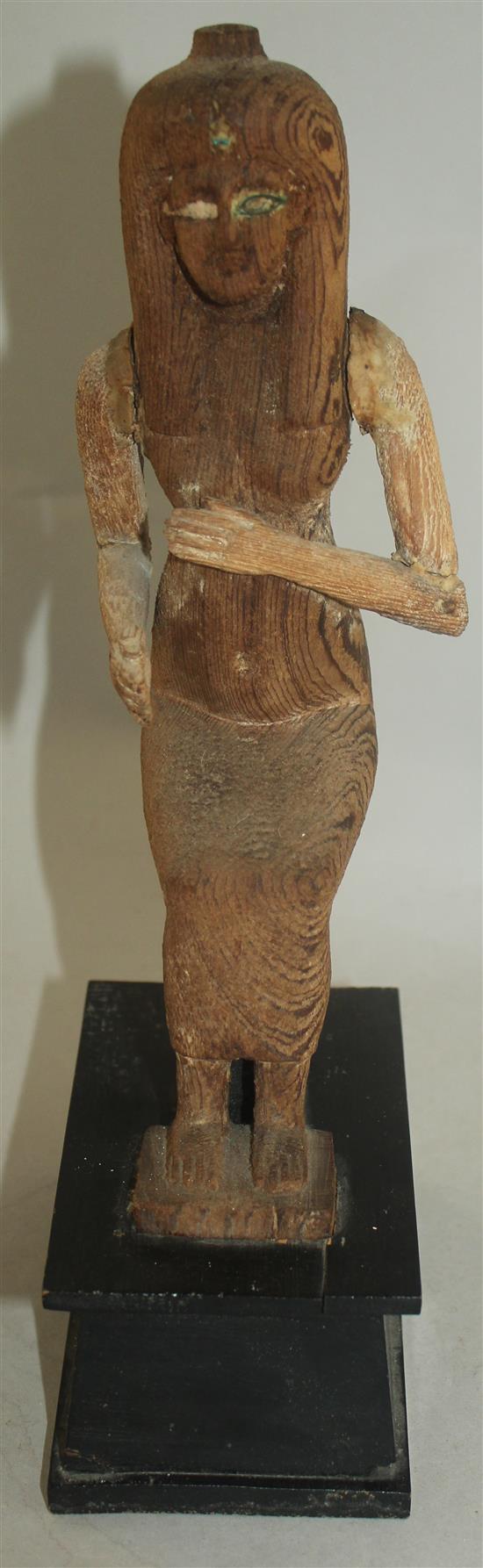 A carved wood figure of a seated ancient Egyptian woman, 12in.